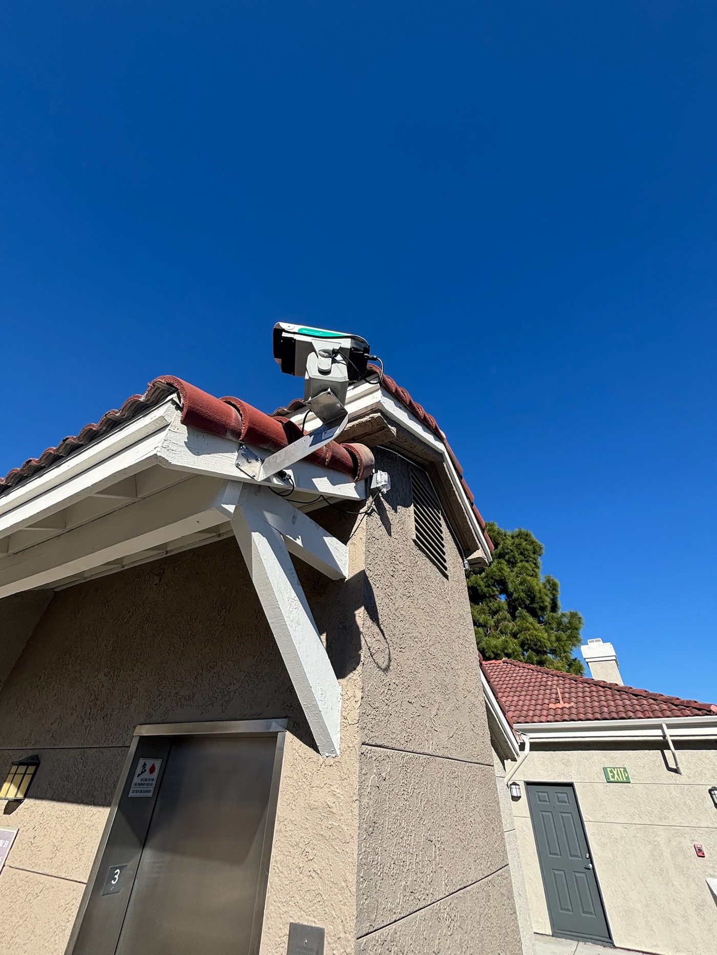 AVIX Autonomic laser unit mounted on a tile roof at a residential HOA property