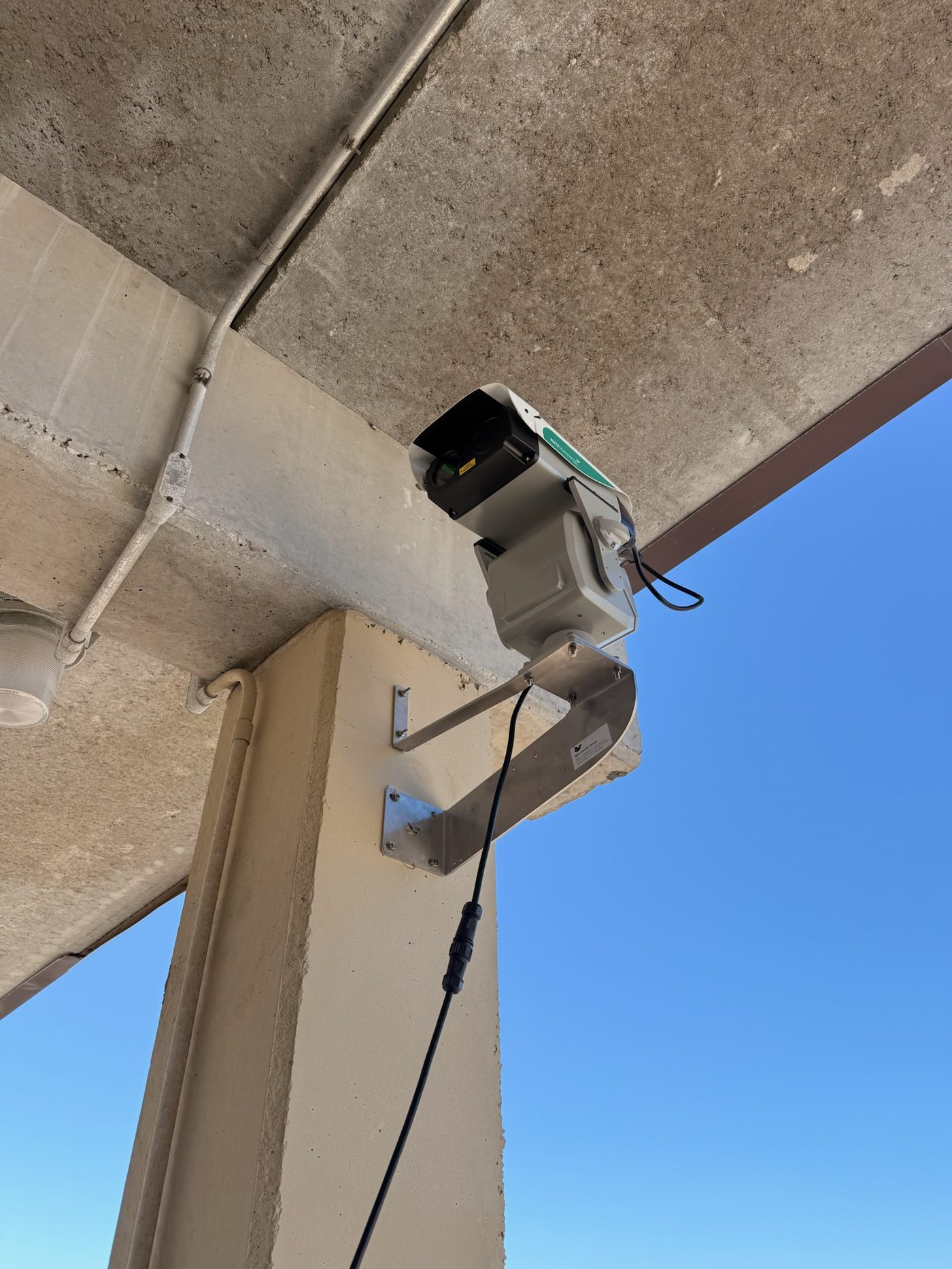 AVIX Autonomic laser unit mounted under a parking garage structure